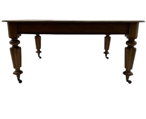 Victorian mahogany dining table, the rectangular top with rounded corners, on turned and lobed supports, brass and ceramic ca