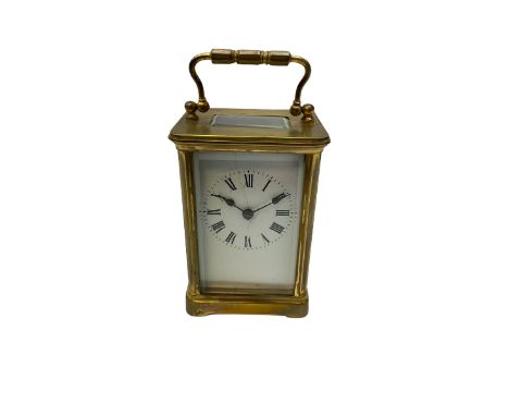 A late 19th century French carriage clock in a Corniche case with a timepiece movement,  white enamel dial , Roman numerals, 