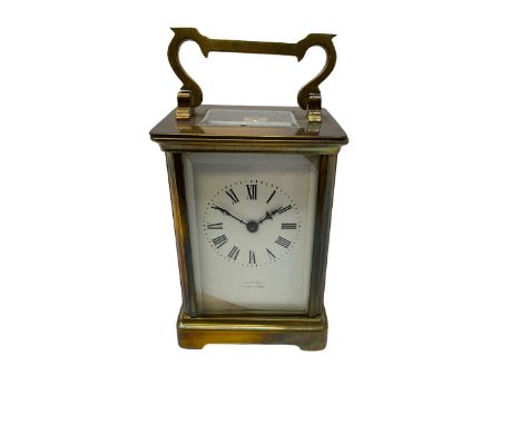 An early 20th century French timepiece carriage clock in a Corniche case with a white enamel dial , Roman numerals, decorativ