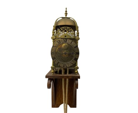 A 20th century replica of a 17th century 30-hour lantern clock with a rope driven verge escapement and countwheel striking, s