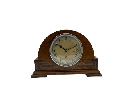 An English chiming mantle clock by Walker & Hall in an arched oak case with rosewood inlay, eight-day spring driven movement 