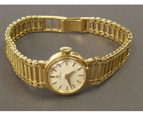 Lady's Omega 18ct gold watch, no. 202458/7037, on reeded chain link bracelet, "750".   Condition Report.  32.2g gross