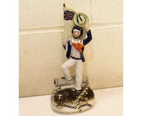 Staffordshire flat back figure of a sailor standing on a bear and cannon, decorated in polychrome and gilt, 30cm.   Condition