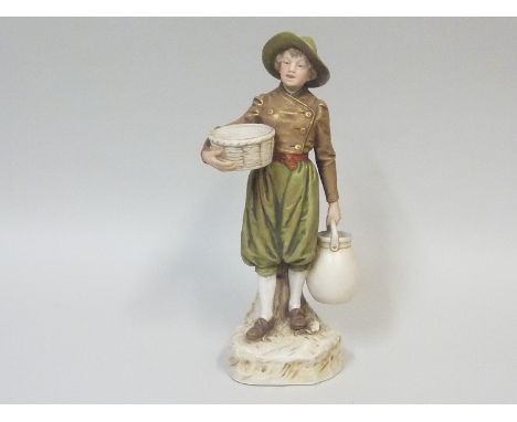 Royal Dux porcelain figure of a boy holding a basket and pitcher, standing on naturalistic plinth base, decorated in typical 