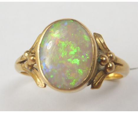 Gold ring with oval opal on beaded shoulders, probably 18ct.