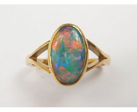 Opal ring in 18ct gold.   Condition Report.  3.6gSize "K" Maybe a doublet but girdle cannot be seen.Approx 9mm x 7mm good min