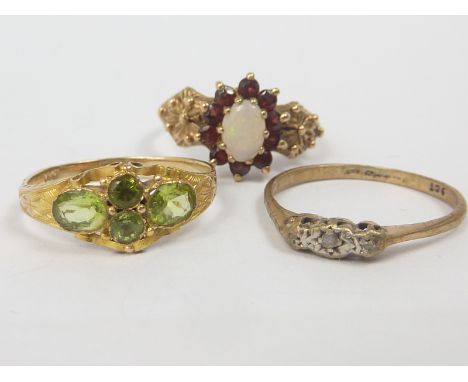 Garnet and opal cluster ring and another, both 9ct, and a peridot ring, "14K". (3)   Condition Report.  6g gross