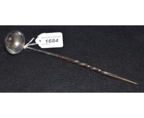 An early 19th century whalebone handle toddy ladle