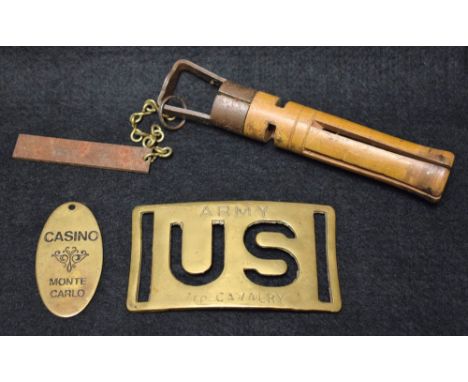 A billiards cue tip file; a US Army brass buckle; a Monte Carlo casino fob