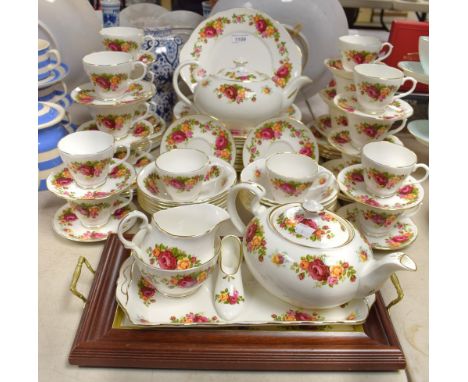 A Staffordshire Royal Imperial dinner and tea service, transfer printed with red and yellow roses, comprising two teapots wit