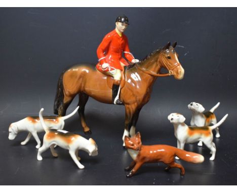 A Beswick huntsman on a bay, designed by Arthur Gredington, 21cm high, model no 1501, printed marks; four hounds, various pos