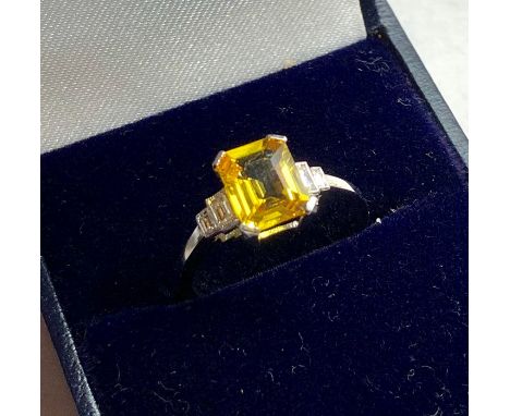 Platinum diamond and yellow sapphire ring large central yellow sapphire measures approx 8mm by 7mm set with diamonds either s