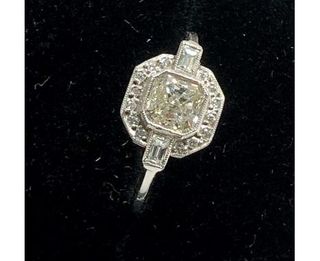 Platinum and diamond ring set with large central diamond with diamonds around central diamond approx 1ct 