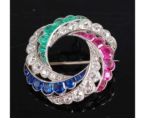 A white metal diamond, emerald, ruby and sapphire wreath brooch, featuring 27 Old European cut diamonds, 9 cap cut emeralds, 