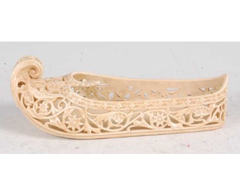 A Royal Worcester old ivory porcelain Indian slipper shoe, with all-over scroll pierced decoration, puce mark, shape No.1180,