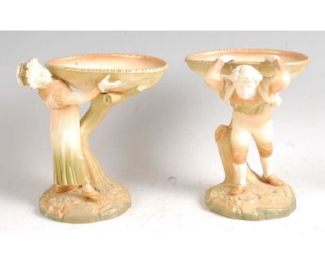 A pair of Hadley Worcester figures in the Kate Greenaway style, each as a rustic boy with basket upon back and a rustic girl 