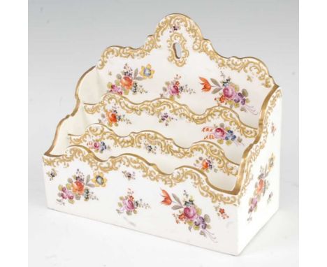 A 19th century porcelain letter-rack, having three tiered sections, polychrome enamel decorated with floral sprays and with g