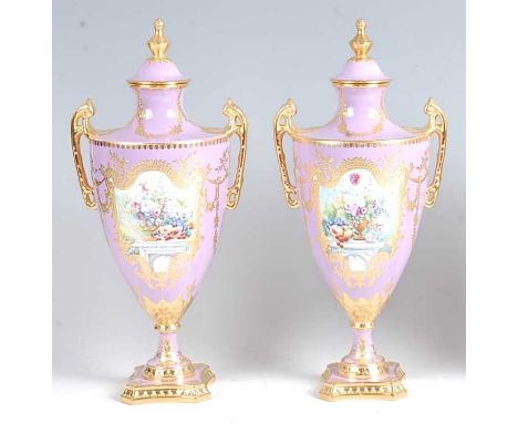 A pair of Lynton Porcelain Co pedestal vases and covers, each of classical urn shape, decorated in bright enamels with a rese