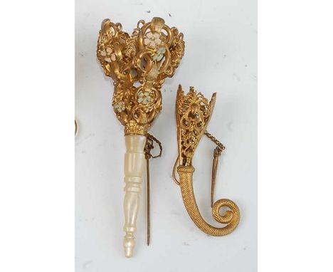 A late 19th century continental gilt metal and enamel decorated posy holder, having turned mother of pearl handle, 13cm; toge
