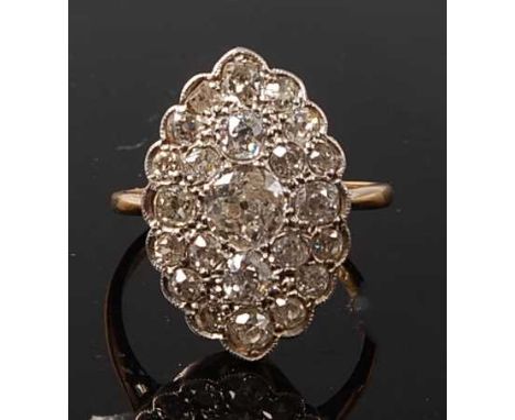 A yellow and white metal marquise shaped panel cluster ring, comprising 33 Old European cut diamonds and one rose cut diamond