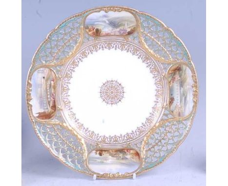 A mid-19th century Copeland porcelain cabinet plate, the reticulated flat rim finely decorated with four reserves of French l