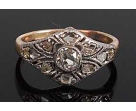 A yellow and white metal Art Deco style lozenge shaped panel ring, featuring a centre Old European cut diamond within an open