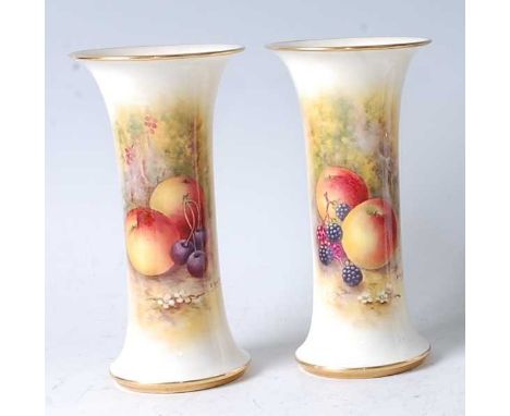 A pair of Worcester porcelain specimen vases, each of waisted trumpet form, decorated with fruit on a mossy bank by E Townsen