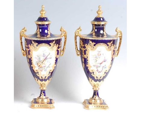 A pair of Lynton Porcelain Co pedestal vases and covers, each of classical urn shape, decorated in bright enamels with a rese