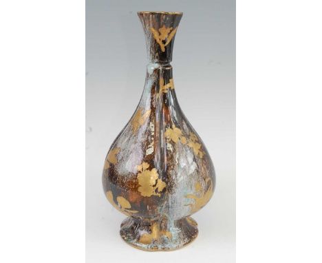 A late 19th century Royal Worcester Japan influenced vase, of lobed panel form, decorated in gilt enamels with leaves and flo