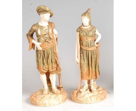 A pair of Hadley Worcester male and female Bringaree Indian figures, each embellished in gilt enamels, puce mark verso and nu