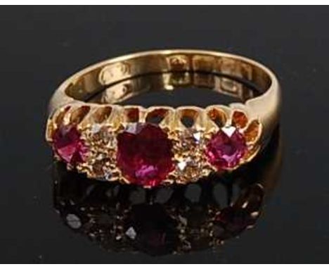 An early 20th century 18ct yellow gold, ruby and diamond seven-stone half hoop eternity ring, featuring three graduated oval 