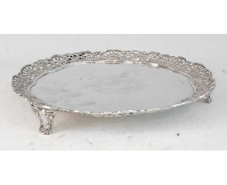 A late Victorian silver salver, having a pierced and chased rim, decorated with gamebirds, flowers and foliage, the central e