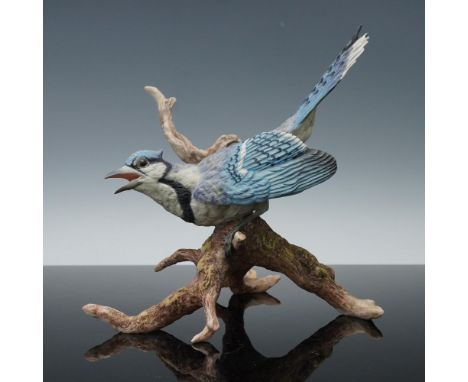 This stunning Boehm porcelain figurine captures the vibrant energy and delicate beauty of a blue jay in full display. The pie