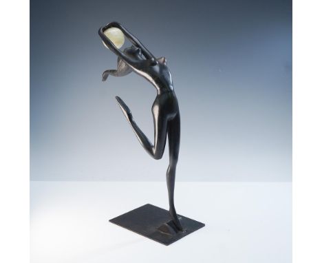 A captivating modernist bronze sculpture depicting a stylized female figure posed gracefully on one leg with both arms raised