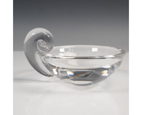 A clear glass bowl featuring a round form with a distinctive snail shell motif handle on a smooth bowl. The base is marked wi