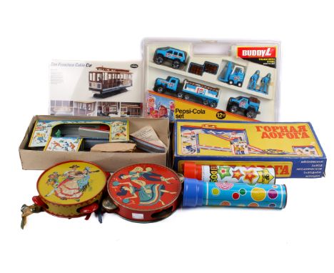 An assortment of vintage toys. Including a boxed Japanese clockwork ski slope, two kaleidoscopes, a boxed Buddy L Pepsi-Cola 