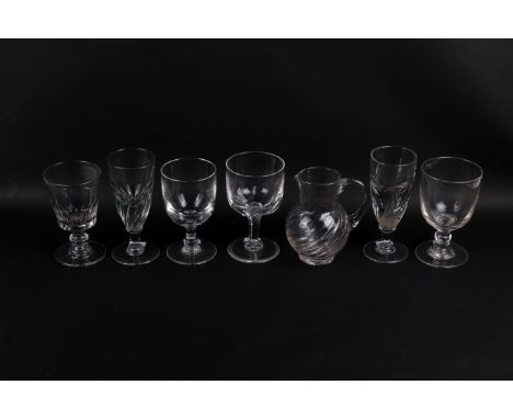 A collection of seven assorted glass items. Consisting of six drinking glasses and a jug. Max. H17cm