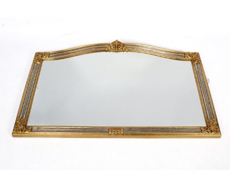 A large arch top gilt framed wall mirror. Bevelled edge glass. Acanthus leaf moulded decoration to the frame. 113cm x 70cm