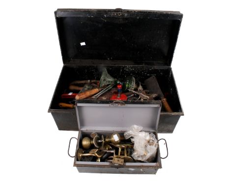 A metal ammunition crate filled with workshop tools. Noting hand operated pillar drills, hammers and set squares, plus a meta