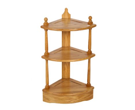 An Ercol blond elm corner what-not. Having turned supports and raised on a plinth base. H80cm x W46cm x D30cm