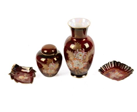 A four piece set of Crown Devon. Comprising two dishes, a vase and a lidded pot, all decorated with gilt and applied floral d