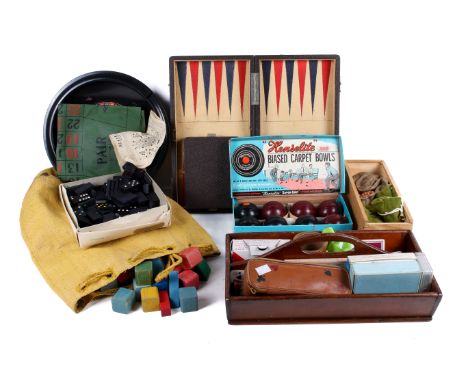 A collection of traditional games. Including a set of draughts, chess pieces, dominoes, etc.