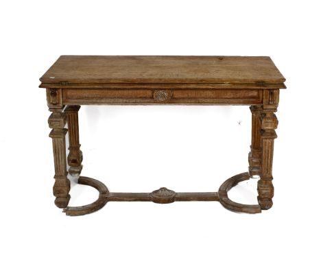 A rustic wooden extendable hall table. Having a hinged plank top, carved decoration, mounted on four tapered ribbed supports,