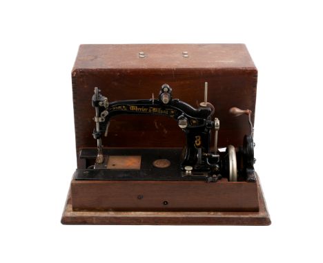 A Wheeler & Wilson No.8 hand crank sewing machine. In a wooden case, L46.5cm