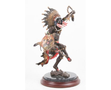 A Franklin Mint 'Spirit of the Thunderbird' painted bronze statue. Modelled as a dancing native American, set on a circular m