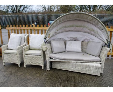 A three piece suite of garden furniture. Including a pair of armchairs and a sofa bed with folding canopy. Max. H90cm