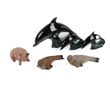 A collection of six mid-century ceramic animal figures. Consisting of three Poole Pottery dolphins, two Aynsley seals and a p