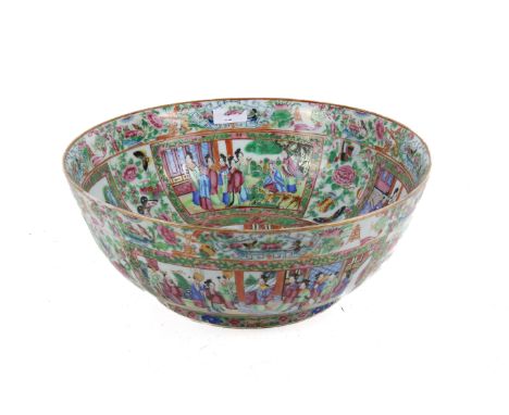 A large late 19th century Chinese Canton enamel famille rose punch bowl. Decorated to the inside walls with four panels of fi