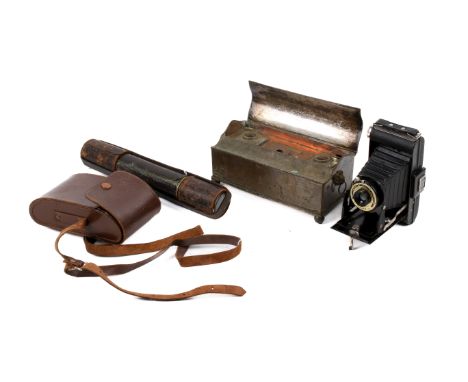 A Victorian telescope, vintage Kodak camera and a desk ink stand. The telescope constructed of brass with a leather cover and