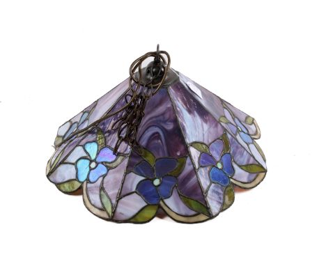 A leaded glass tiffany style lamp shade ceiling pendant. Having blue floral decoration on a purple marbled ground, H20cm x di